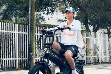 A Caucasian man riding a gray Aniioki A8 Pro Max electric bike on an urban street