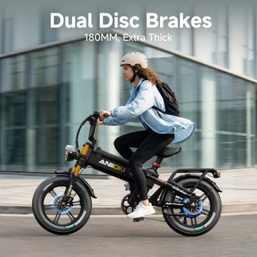 Person riding an Aniioki A8 60V electric bike featuring dual disc brakes and 180MM thick tires.