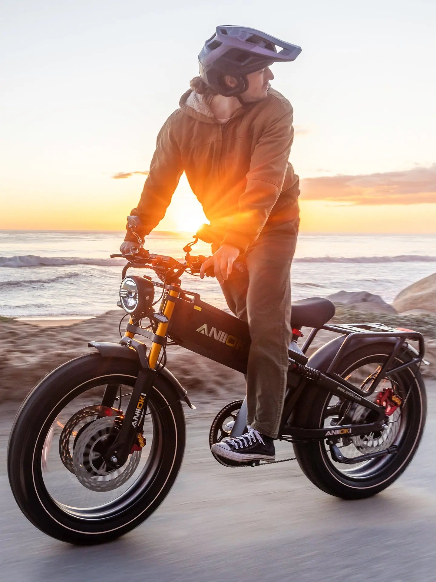 Aniioki A9 Pro Max 2026 version cruising on a sandy beach during sunset, demonstrating the traction of its 4.8-inch fat tires.